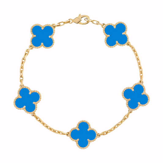 Gold bracelet with blue clover-shaped charms on a white background