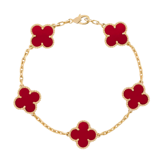 Gold bracelet with red clover-shaped charms on a white background