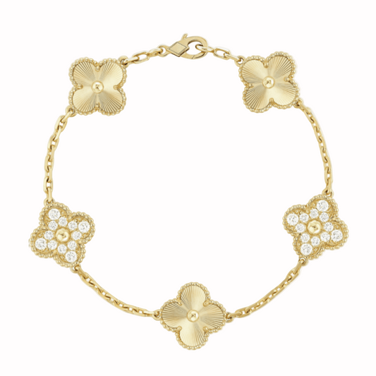 Gold bracelet with floral designs on a white background